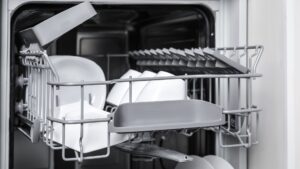 An open dishwasher with dishes standing in both baskets ready for a cycle